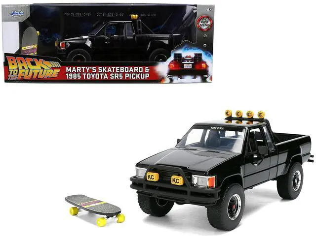 Main image of 1985 Toyota SR5 Pickup Truck Black with Marty's Skateboard "Back to the Future" (1985) Movie 1/24 Diecast Model Car by Jada
