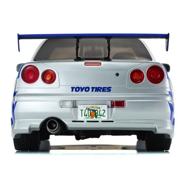 Alt view image 5 of 6 - Nissan Skyline GT-R (R34) RHD Silver Metallic with Blue Graphics "2 Fast 2 Furious" (2003) Movie 1/12 Model Car by Kyosho