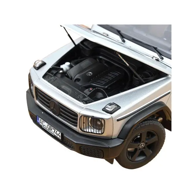 Alt view image 4 of 7 - 2024 Mercedes-Benz G-Class Professional Iridium Silver Metallic with Black Top and Roof Rack 1/18 Diecast Model Car by Norev
