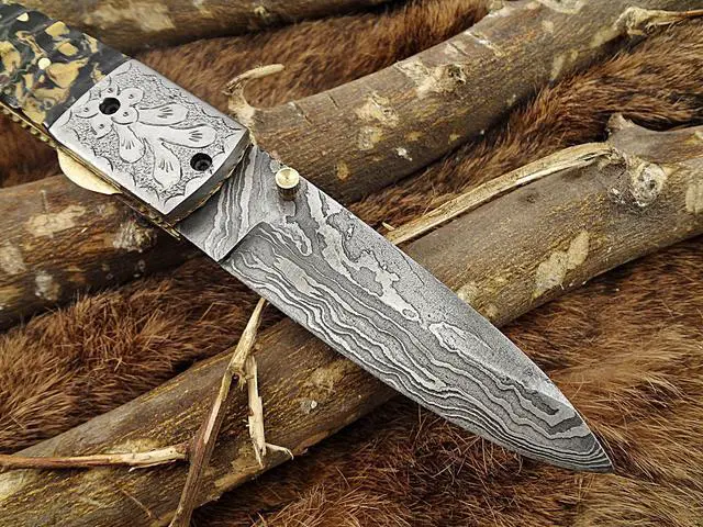 Alt view image 6 of 7 - Damascus Steel Folding knife, Exotic Jigged scale in Camouflage color, Thumb knob & liner lock, Cow Leather sheath (Camouflage)