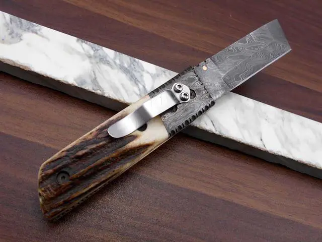 Alt view image 4 of 7 - Damascus steel Tanto blade Folding Knife, Available in Natural Ram, Bull horn, Camel Bone, Stag Antler scales with Damascus bolster, Cow hide leather sheath, equipped with Thumb knob & liner lock