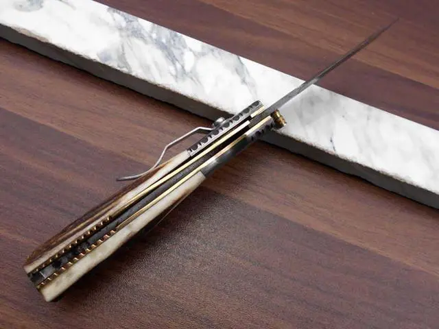Alt view image 7 of 7 - Damascus steel Tanto blade Folding Knife, Available in Natural Ram, Bull horn, Camel Bone, Stag Antler scales with Damascus bolster, Cow hide leather sheath, equipped with Thumb knob & liner lock