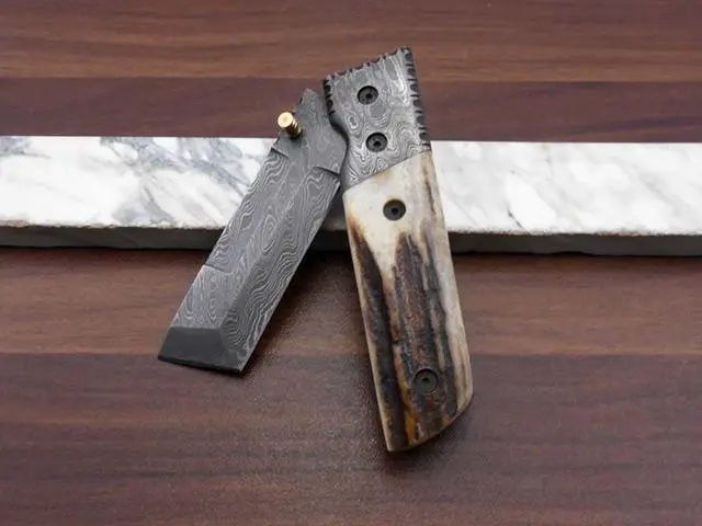 Alt view image 5 of 7 - Damascus steel Tanto blade Folding Knife, Available in Natural Ram, Bull horn, Camel Bone, Stag Antler scales with Damascus bolster, Cow hide leather sheath, equipped with Thumb knob & liner lock