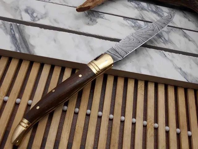 Alt view image 2 of 5 - Laguiolle Folding Damascus steel knife. hand forged custom twist pattern 4" Blade. Available in various scales with brass bolster. Cow hide leather sheath Included