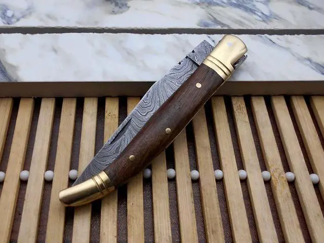 Alt view image 3 of 5 - Laguiolle Folding Damascus steel knife. hand forged custom twist pattern 4" Blade. Available in various scales with brass bolster. Cow hide leather sheath Included