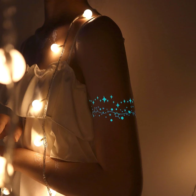 Alt view image 6 of 7 - Blue Luminous Temporary Tattoos Glow in the Dark Music Festival Moon Tattoos Waterproof Planet Star Fake Tattoo Sticker for Women Men Face Body Arm Party Cute Skin Tattoo Decorations