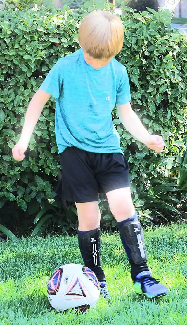 Alt view image 6 of 7 - Swell Relief Soccer Shin Guards for Kids/Soccer Gear for Boys Girls/Protective Soccer Equipment/Adjustable Straps (Red, Medium)