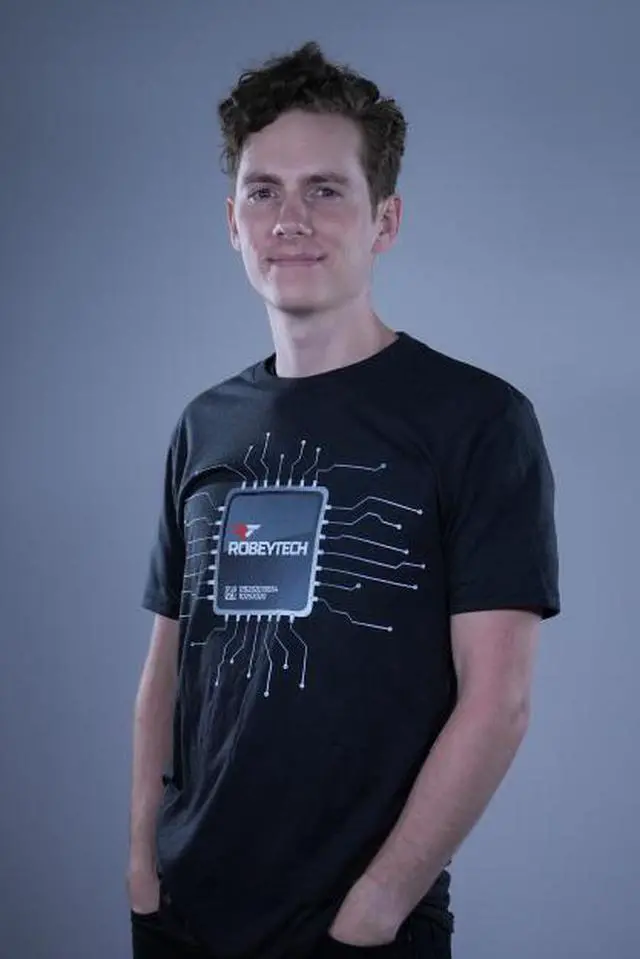 Main image of The CPU Tee - Our Premier Robeytech Tee is all about YOU.  This awesome CPU design marks the date you helped us get out our first YouTube Video AND the date we first hit 100K in Subscribers.