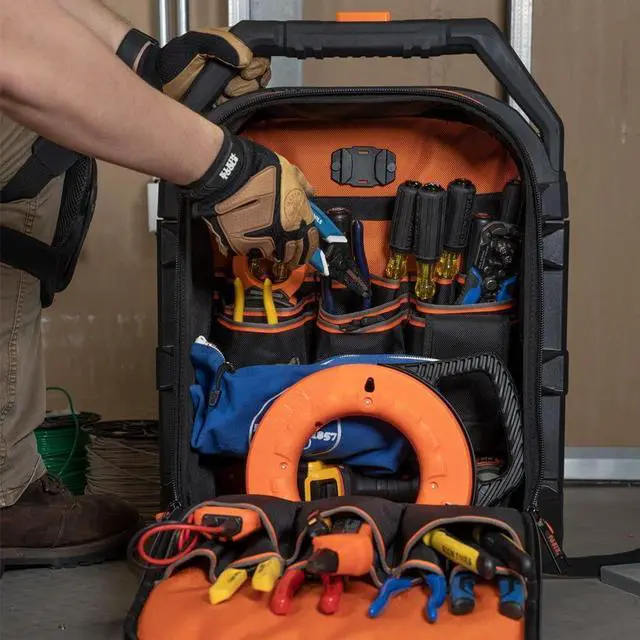 Alt view image 4 of 6 - Klein Tools  Rolling Tool Backpack, Tool Bag with 28 Pockets, Heavy Duty Retractable Handle, Large Tool Storage Interior, 3-Inch Wheels