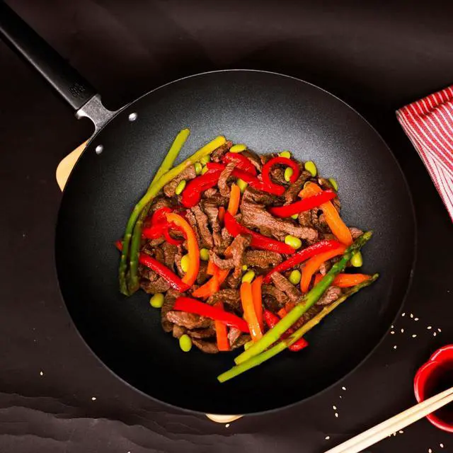 Alt view image 6 of 7 - JOYCE CHEN Professional Series 12-Inch Carbon Steel Excalibur Nonstick Stir Fry Pan with Phenolic Handle