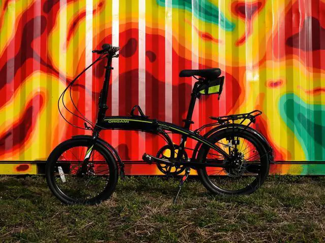 Alt view image 4 of 4 - The Origami Gazelle is a great companion for anyone wanting a versatile and lightweight folding bike. Its 8-speed gear set and disc brakes make it a great commuter or weekend bike. black/neon green