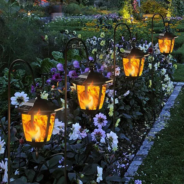 Alt view image 7 of 7 - Dynaming 4 Pack Solar Flame Hanging Lights Outdoor, Halloween Solar Flickering Flame LED Garden Lanterns with 4 x 38 Inch Shepherd Hooks, Christmas Lighting for Lawn Patio Yard Pathway Driveway
