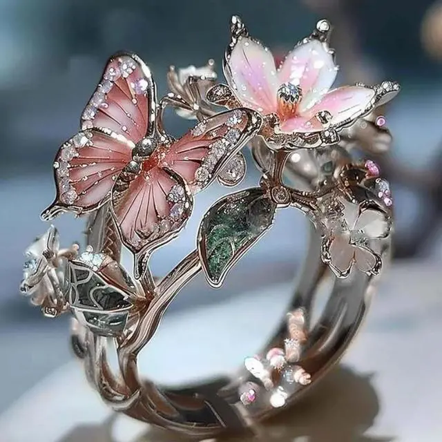 Main image of A golden lady's butterfly-shaped ring, with flowers as the theme, featuring a butterfly-shaped adjustable band, a ring for ladies.