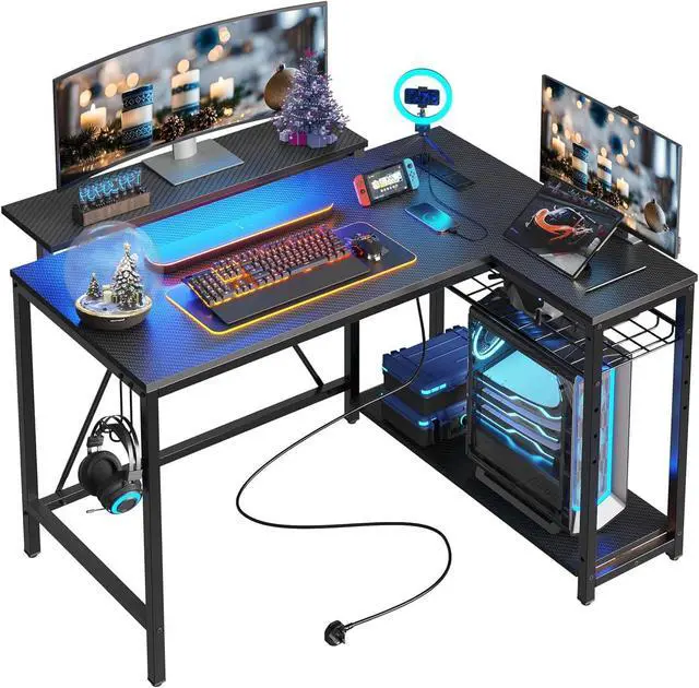Main image of Bestier Gaming Desk with Power Outlets, 42" L-Shaped Computer Desk with LED Lights, Desk with Reversible Storage Shelves & Hooks for Small Spaces, Bedrooms & Offices, Black Carbon Fiber