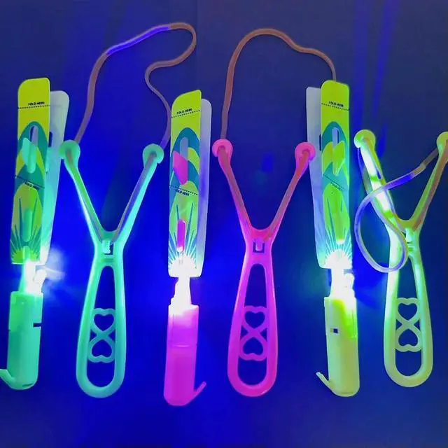 Alt view image 5 of 6 - Rocket Slingshot Flying Toys with LED Lights 10Pcs LED Arrow Helicopters + 10Pcs Launchers Glow in Dark Rocket Helicopter Toys