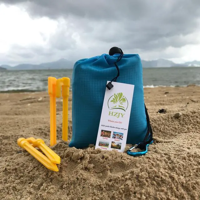 Alt view image 6 of 7 - Pocket Blanket 71"x55", Lightweight Compact Sandproof Waterproof Outdoor Blanket for Beach, Hiking, Camping, Travel, Festivals, Picnic with Pockets, Loops, Stakes, Carabiner