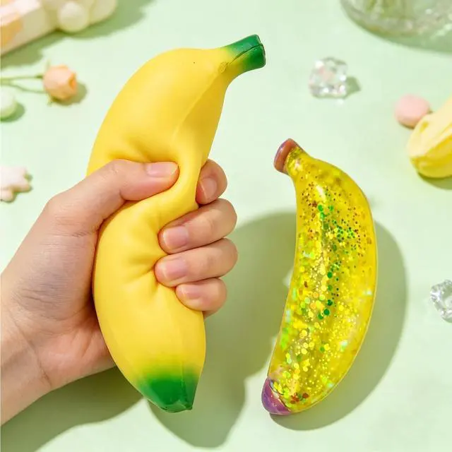 Alt view image 6 of 7 - 2 PCS Banana Squishies, Giant Banana Squishies with Sparkle Glitter, Stress Relief Sensory Tool for Office Desk, Including Jumbo Bananas Stress Ball and Sparkle Bananas Stress Ball, 7'' and 5''