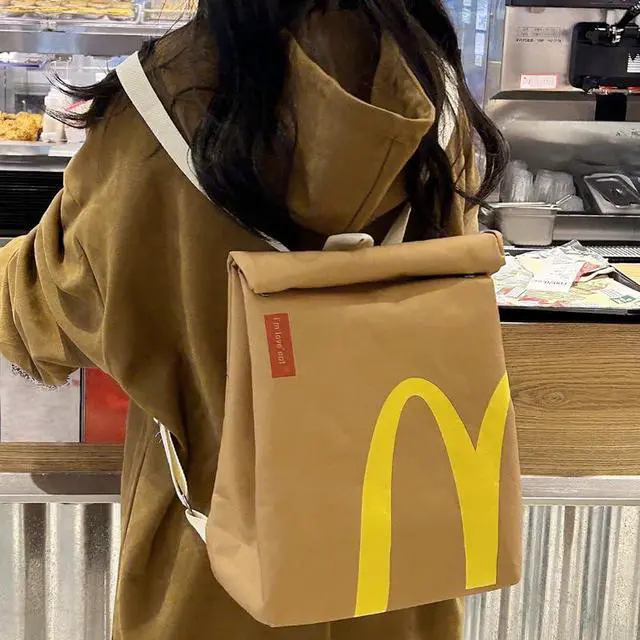 Alt view image 5 of 7 - Classic Funny Retro Paper Bag Large Capacity Backpack Cute Personalized Shoulder Crossbody Canvas Backpack Notebook