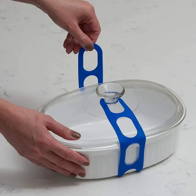 Alt view image 2 of 3 - Lid Latch the reusable universal lid securing strap for crockpots, casserole dishes, pots, pans and more. Make it easy to transport your favorite dishes with one simple strap. (Polybag Blue/Grey)