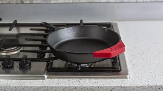 Alt view image 2 of 3 - Silicone Assist Handle Holder - Dishwasher Safe Hot Handle Holder Designed for Traditional Lodge Cast Iron Dual Handle Products - Reusable Heat Protection Up to 450° - Red