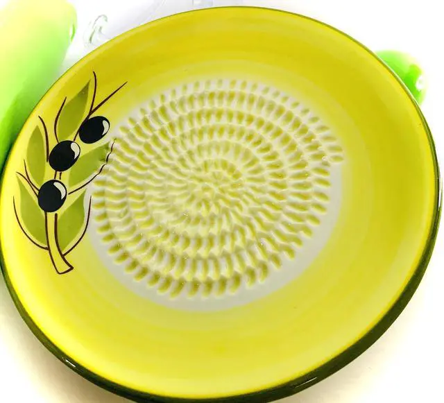 Main image of All-in-one Premium Ceramic Garlic Grater Plate 4-Piece Set - Yellow Olive Design, Classic Style - For Garlic, Ginger, Chocolate, and more! - Comes with 5.25" Plate, Peeler, Brush, and Stand