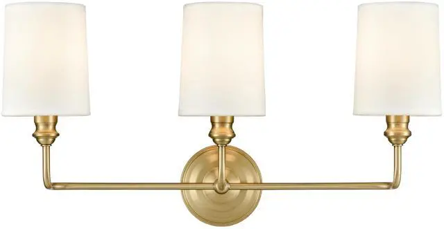 Main image of Leena Collection | 99803-VB | Indoor 3 Light Vanity in Vintage Brass with White Fabric Shade | Elegant and Versatile Design for Any Bathroom
