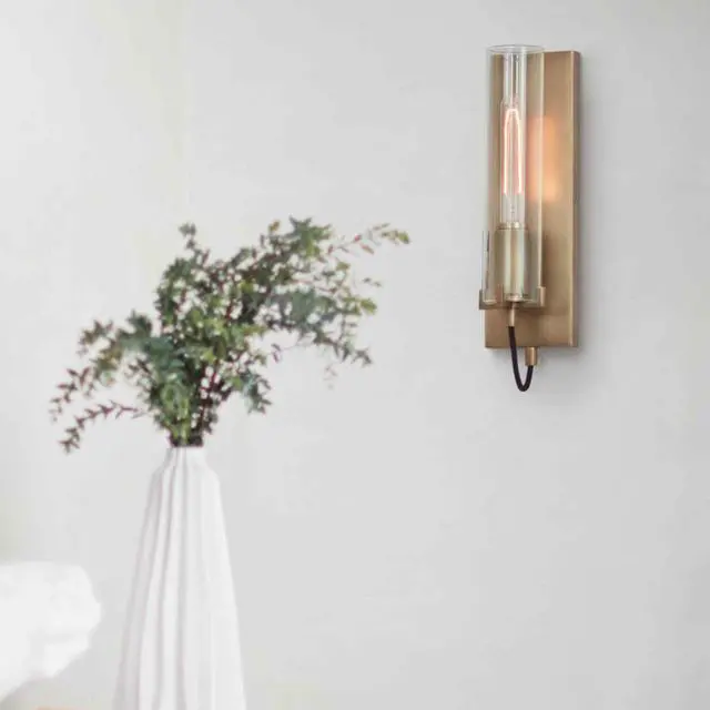 Alt view image 2 of 6 - Ryden Medium Indoor Single Light Wall Sconce, Heritage Brass Finish | Clear Glass Cylinder Shade, Modern Industrial, Sleek, Includes Med. LED Bulb, Shown w/ T-Style Bulb, Hidden Mounting Hardware
