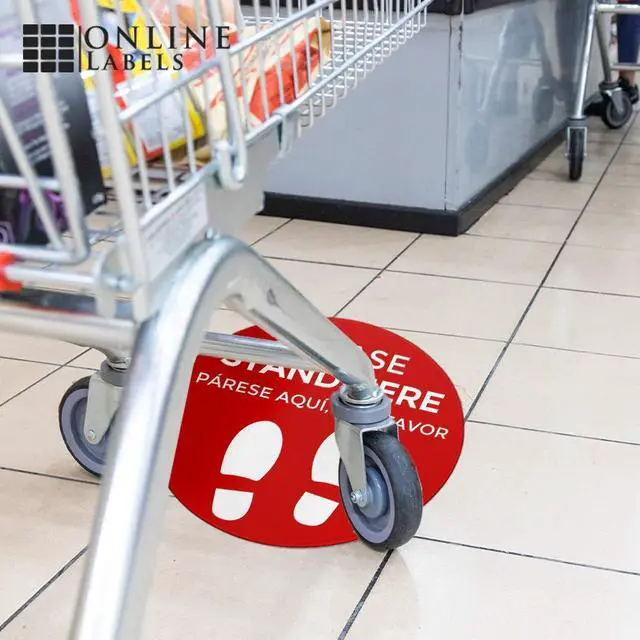 Alt view image 5 of 6 - Social Distancing Floor Signs in English & Spanish - Pack of 25 Stickers - Red Stand Here Design - 12 Inch Circle - Indoor Only - Removable Adhesive Vinyl