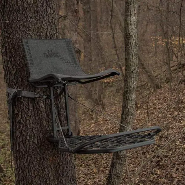 Alt view image 6 of 7 - Kickback Lvl Hang on Tree Stand HWK HF2031, 24x30 Platform | 24x30 in Welded Platform, Xl Mesh Seat 21x15 in, Steel Construction, 300 Lb Capacity, Kickback Footrest