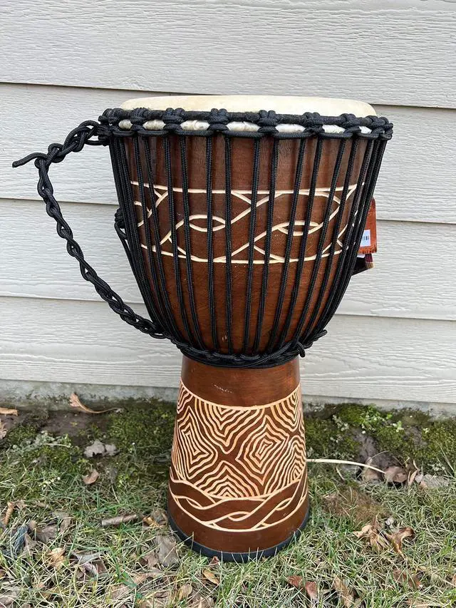 Alt view image 2 of 4 - Djembe Standard Line Carved Mahogany Wood with Natural Goat Skin, 24" Tall, 12" Head, Model NK047