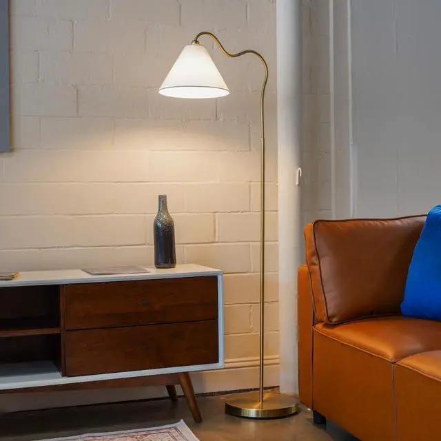Main image of Majestic Brass Ring Base Curved Floor Lamp with Triangle White Drum Shade