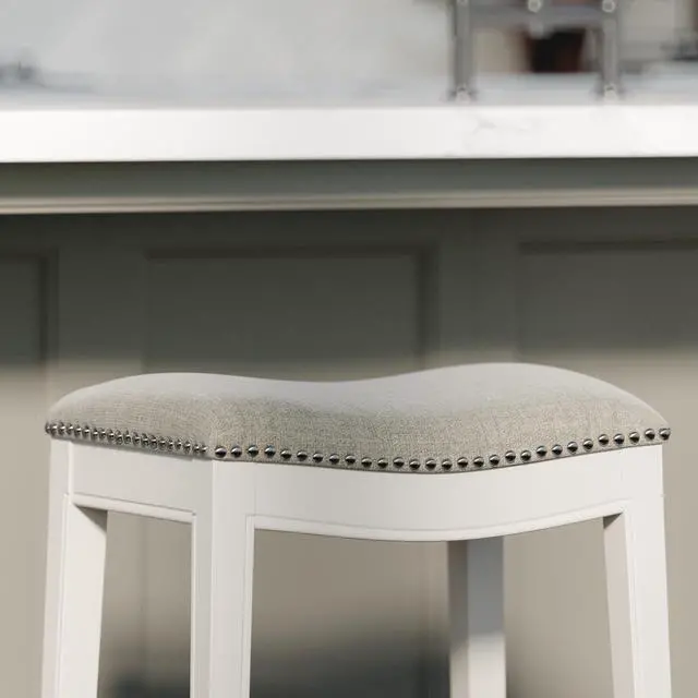 Alt view image 4 of 7 - 26in. Counter-Height Backless Wood Saddle-Seat Barstool with Nailhead Trim, Farmhouse Whitewash with Gray Upholstered Seat, 1PC