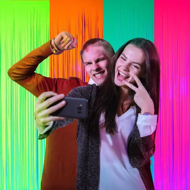 Alt view image 6 of 7 - Glow in The Dark Party Supplies 4 Pack 3.3x6.6ft Neon Party Decoration Neon Tinsel Foil Fringe Curtain 2026 Vbs Photo Booth Backdrop Streamer for Birthday Decor(Green, Rose Red, Yellow, Orange)