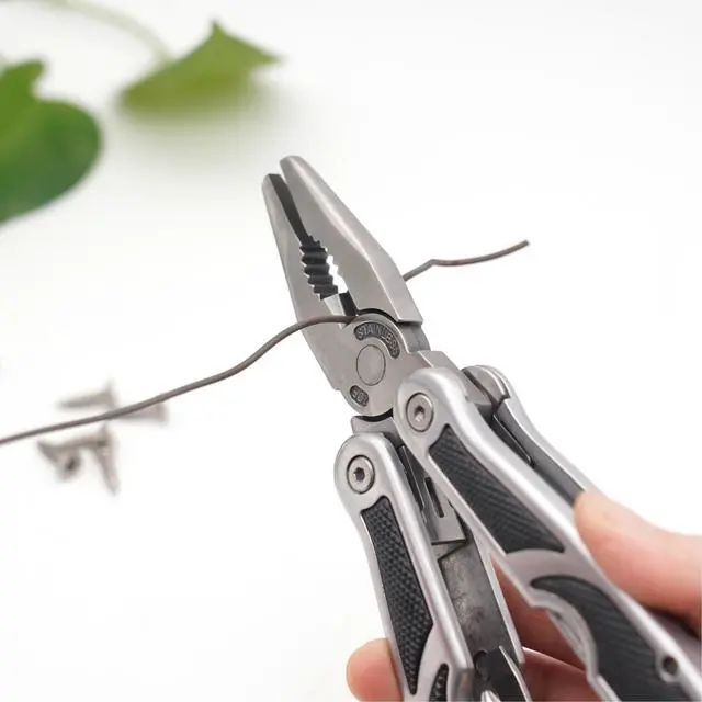 Alt view image 5 of 7 - PLB027 stainless steel multi-function plier. 27 functions with knife, fish scaler, screwdrivers, can and bottle opener, 11 bits and 1 socket. Hand size and easy to carry and use indoor, outdoor