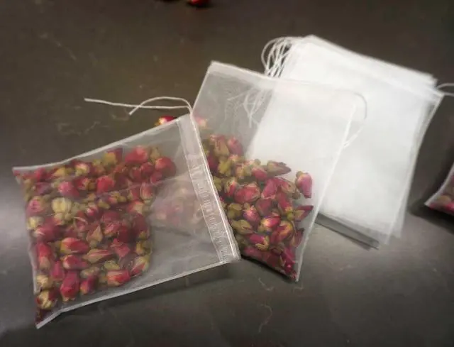 Alt view image 2 of 7 - 50Pcs Empty Pyramid Nylon Tea Bags Mesh Tea Infuser Bag Herb Spice Filter Strainer Bags With String (3.93x4.7inch)