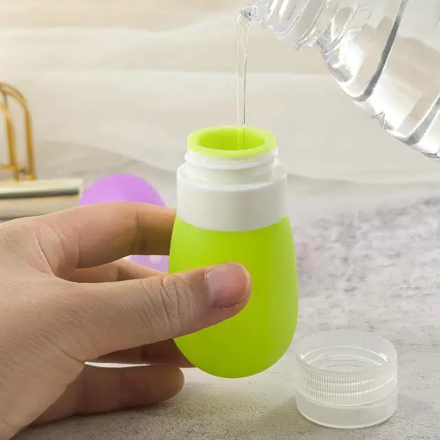 Alt view image 5 of 7 - Mziart Travel Bottles for Toiletries, TSA Approved 2oz Silicone Travel Size Containers, 3 Pack Leak-Proof Squeezable Refillable Shampoo and Conditioner Bottles (Pink, Purple, Green)