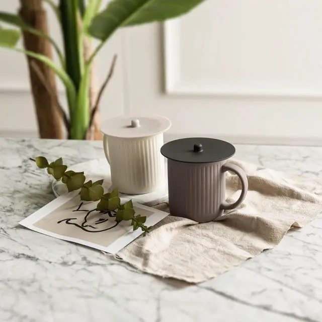 Alt view image 6 of 7 - Carrotez Silicone Cup Cover Lids, 4.3 Inch, 2 Pack - Black | Mug Covers, Reusable Silicone Coffee and Tea Cup Lids