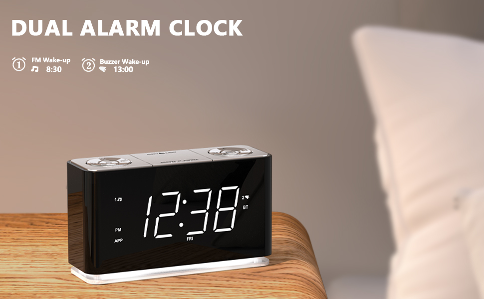 Modern rectangular digital alarm clock with white LED display showing 12:30, featuring dual alarm functionality and a black and white color scheme.