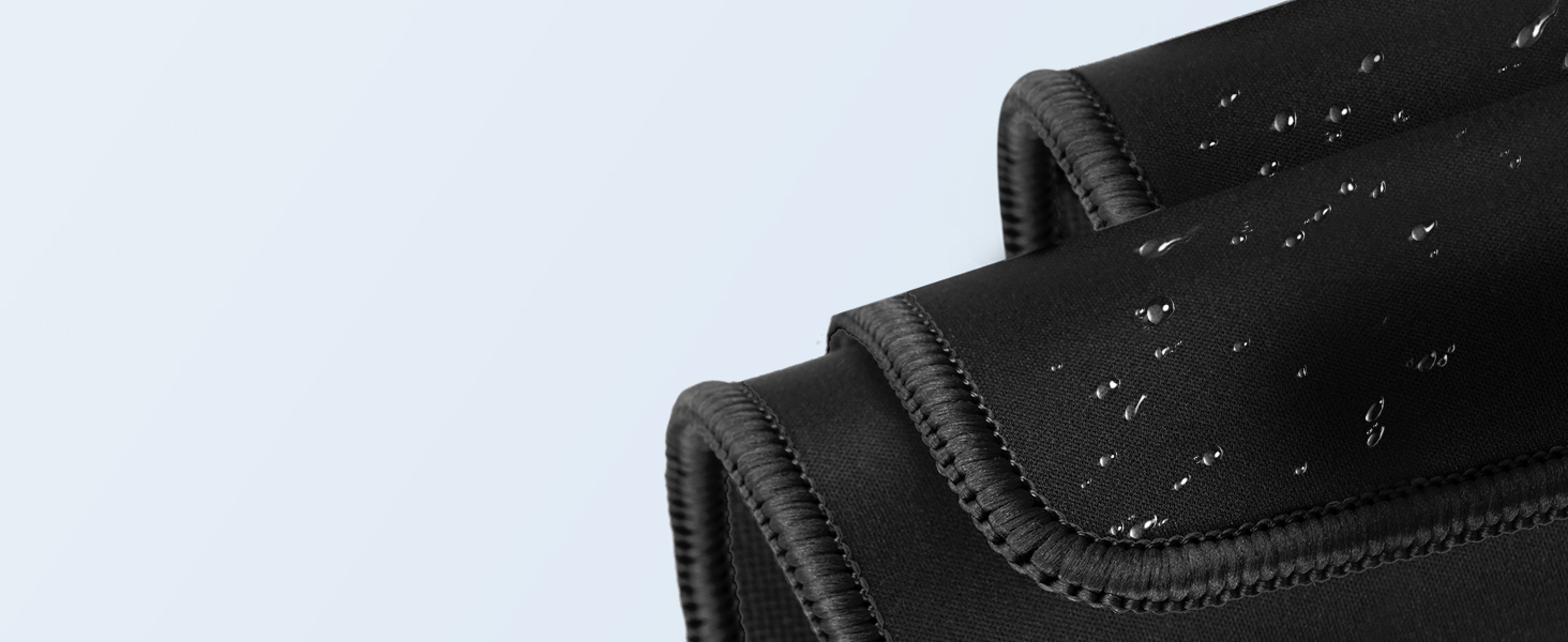 Close-up of black neoprene-like material with water droplets on the surface, suggesting water-resistant properties. Multiple layers or folds visible.