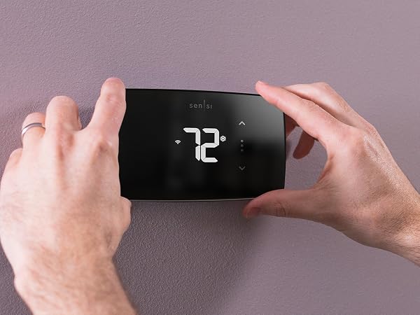 Sensi Lite on the wall with hands holding it mobile version