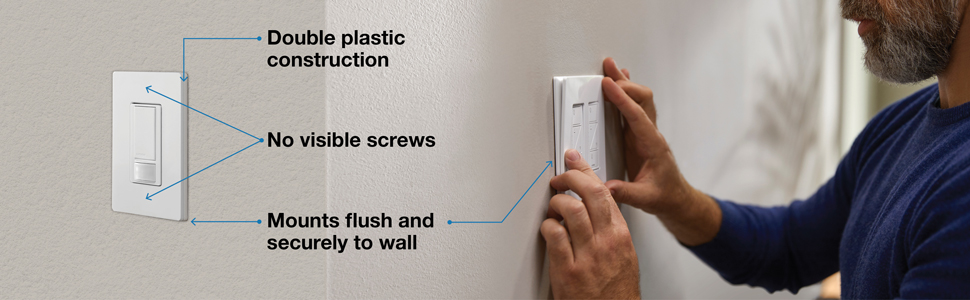 A person installing a wallplate onto a wall.