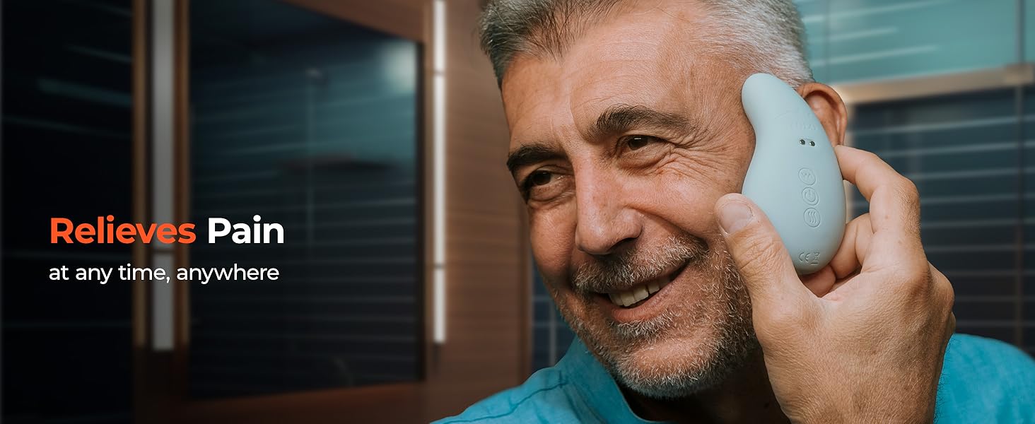 person holding the TMJ massage tool against their cheek and smiling