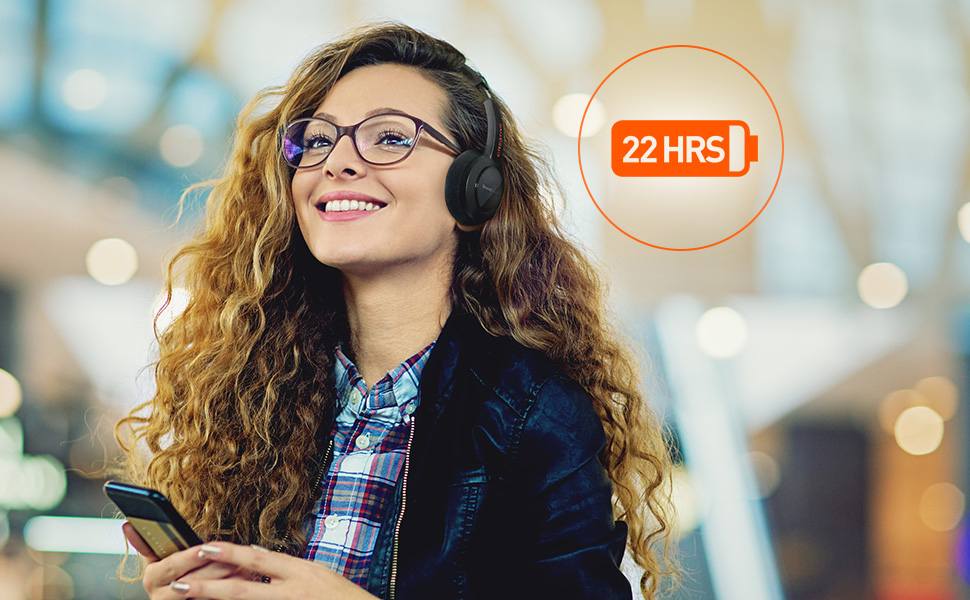 woman smiling at the mall, using phone and Sound Blaster JAM V2, 22 hours battery life