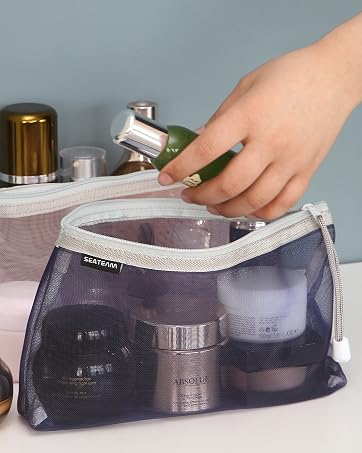 A hand is taking a bottle of cosmetic from the cosmetic bag