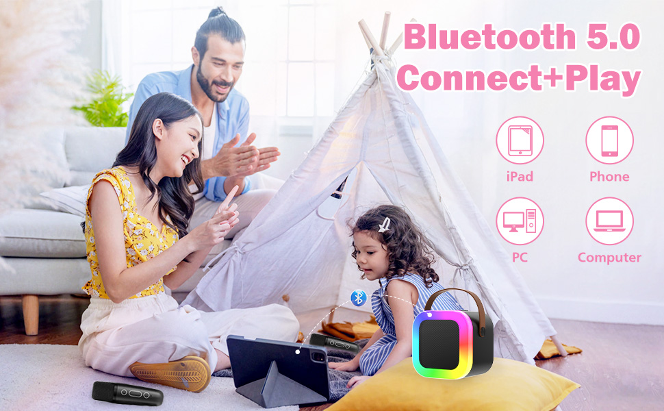 Text reads 'Bluetooth 5.0 Connect+Play' with pink text and icons. Marketing image showing family using electronic device in home setting.