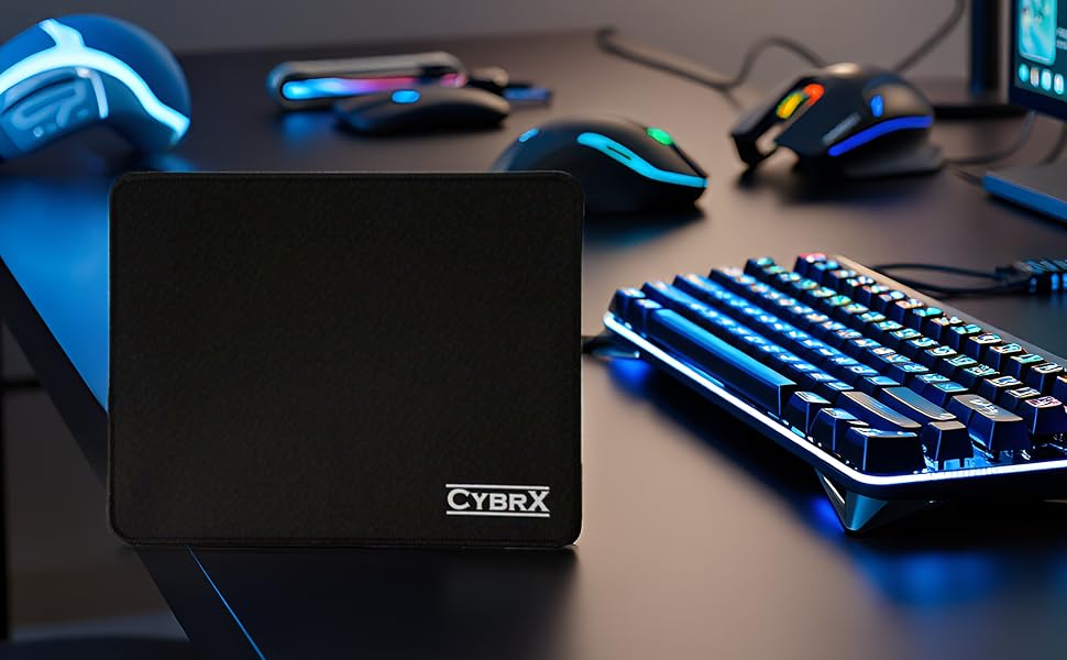 Gaming mouse pad on RGB setup desk with keyboard, headset, and CybrX logo