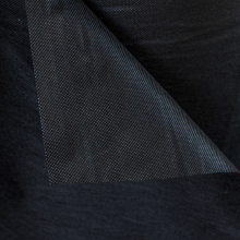 Folded black cambric dust cover fabric used for upholstering and protecting furniture bottoms