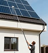 Solar panel installation scene showing maintenance or installation work being performed on rooftop-mounted solar panels.