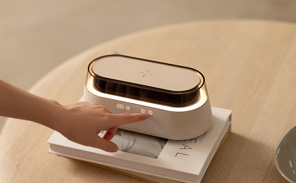 Close-up of a metallic or electronic device with curved edges and textured surface, placed on paper documents.