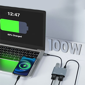 100W charging station connected to laptop showing battery status, with multiple USB ports visible in sleek modern design.